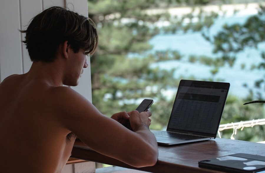 topless man using black laptop computer