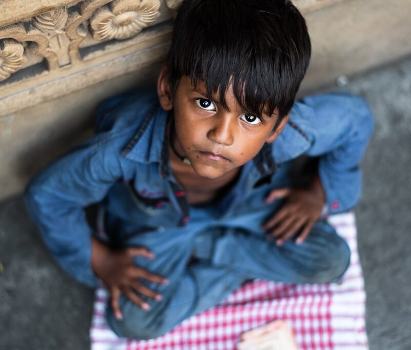 boy sitting and leaning while looking up