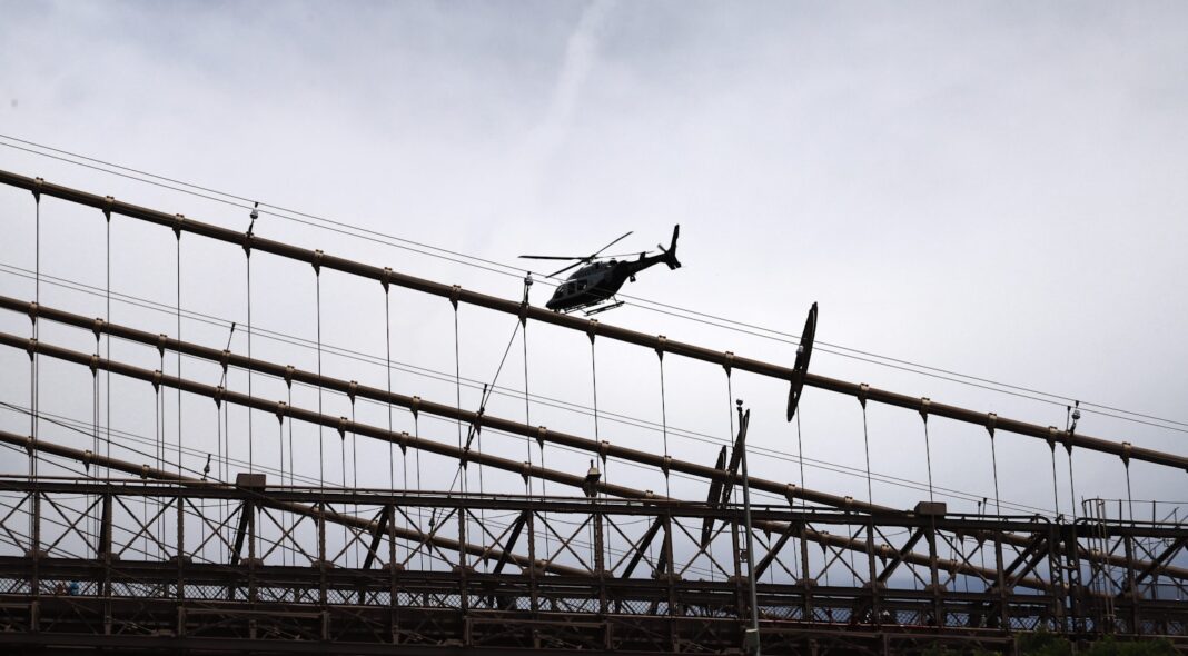 a helicopter flying over a power line