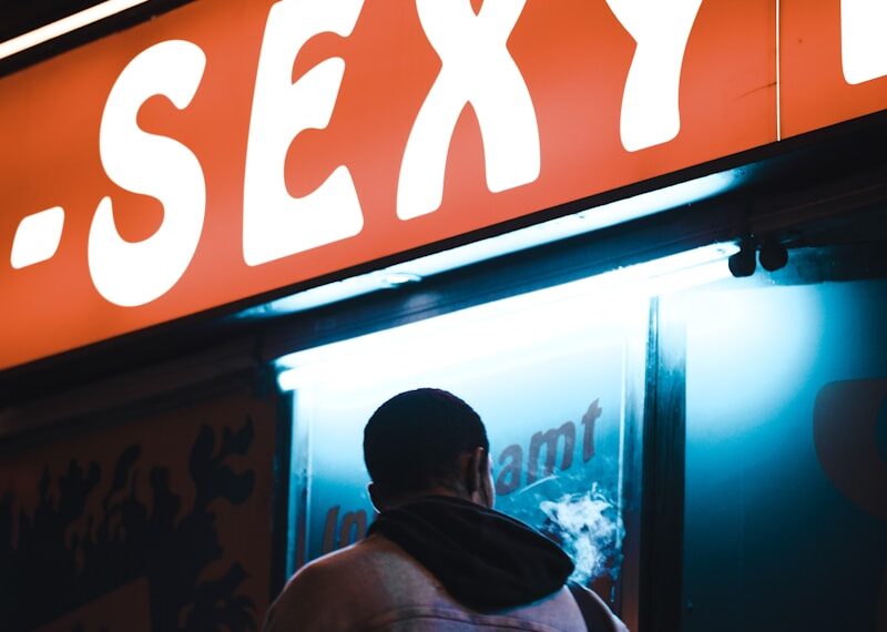 a man standing in front of a sexy bar