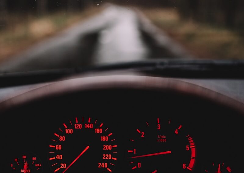 a car dashboard with a red light