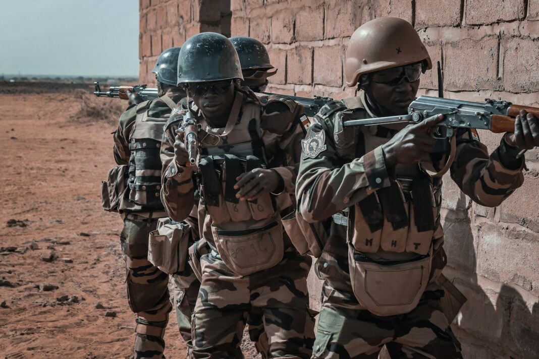 Soldiers are on patrol with their weapons ready.