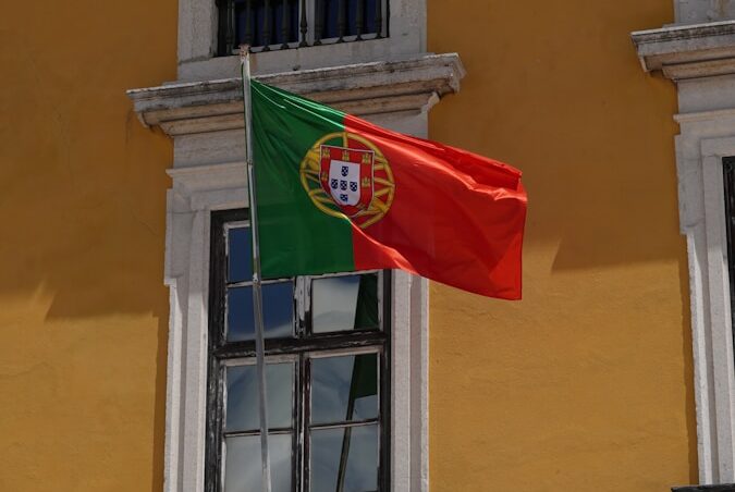 A flag flying in front of a building