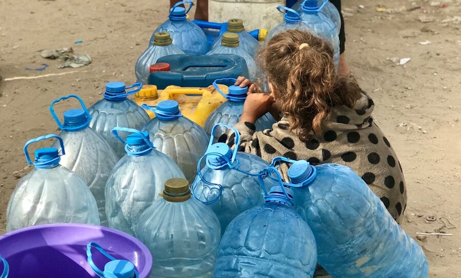 a group of people standing around a table filled with water bottles