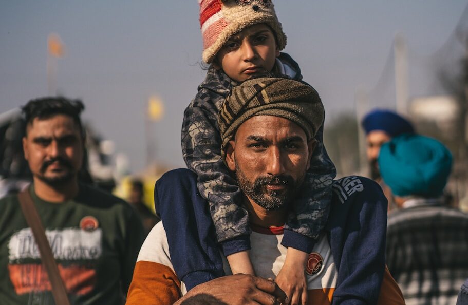a man carrying a child on his shoulders