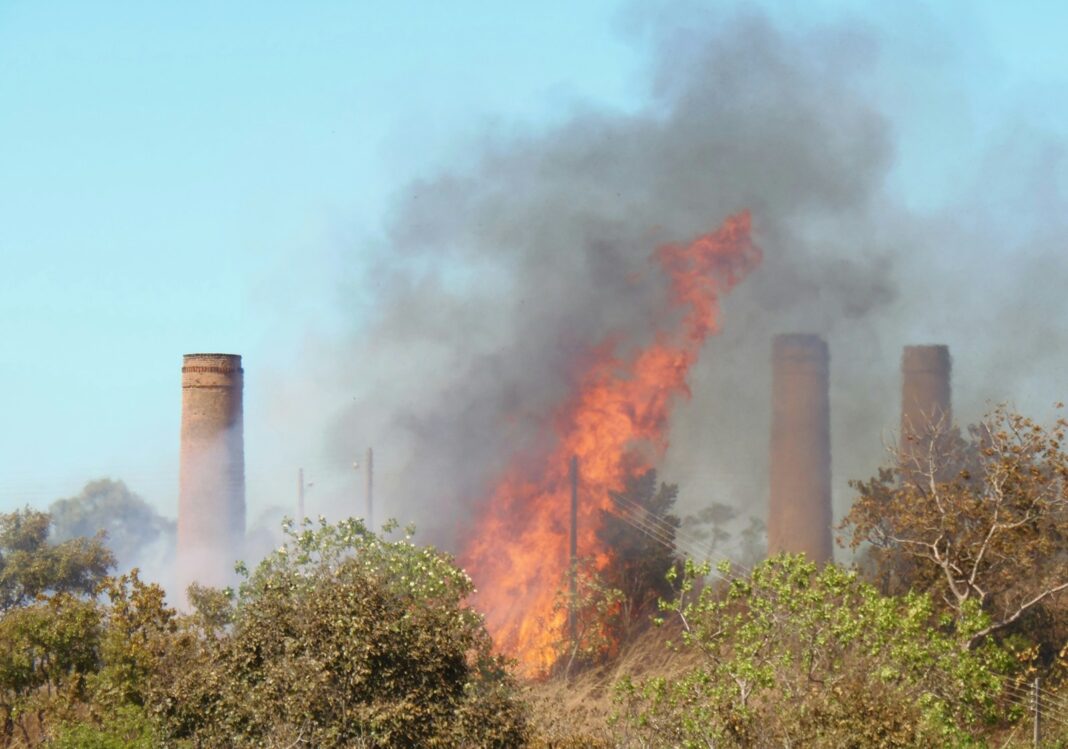 A factory with a lot of smoke coming out of it