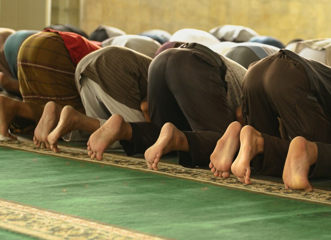A group of men standing in a line on a rug