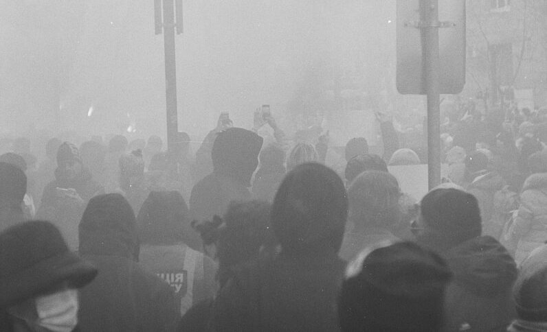 grayscale photo of people standing on stage