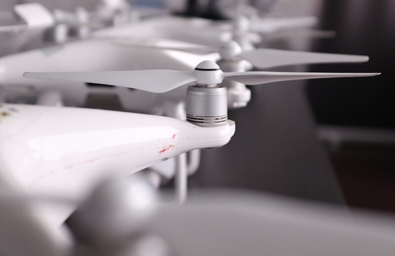 several white drones lining up on table