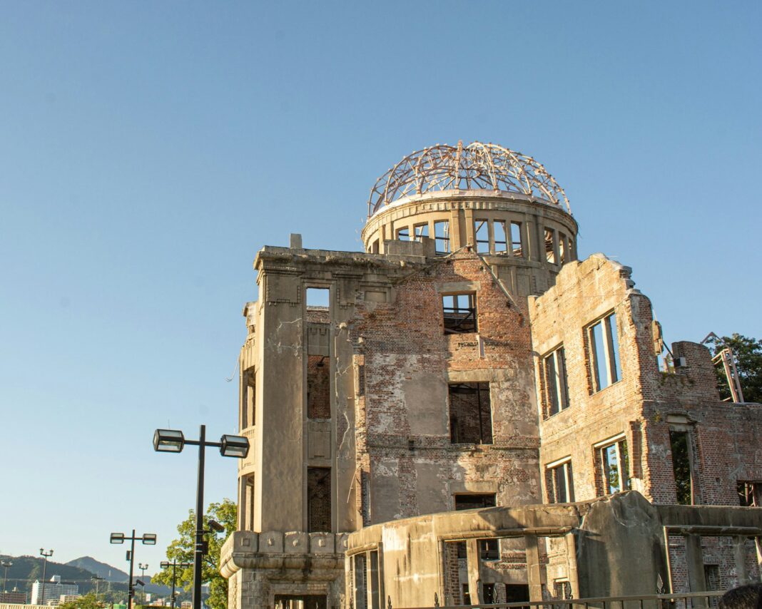 a large stone building with Hiroshima Peace Memorial in the background