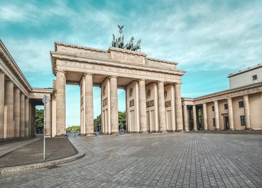 a stone arch with a statue on top of it
