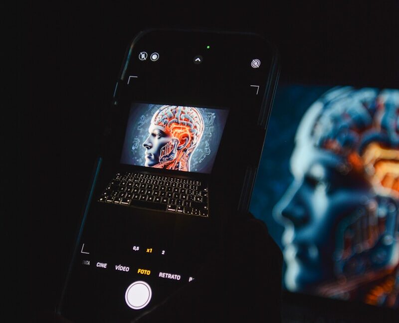 a cell phone sitting on top of a laptop computer