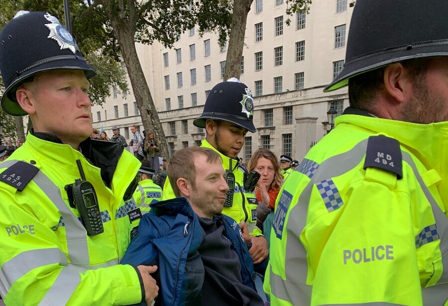 four policemen carrying men