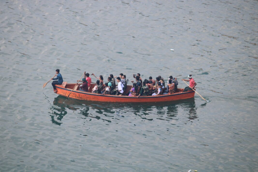 People are riding in a boat on the water.