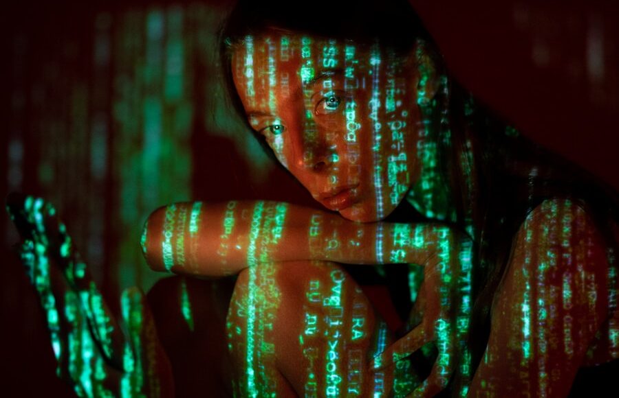 a woman is holding a cell phone in the dark