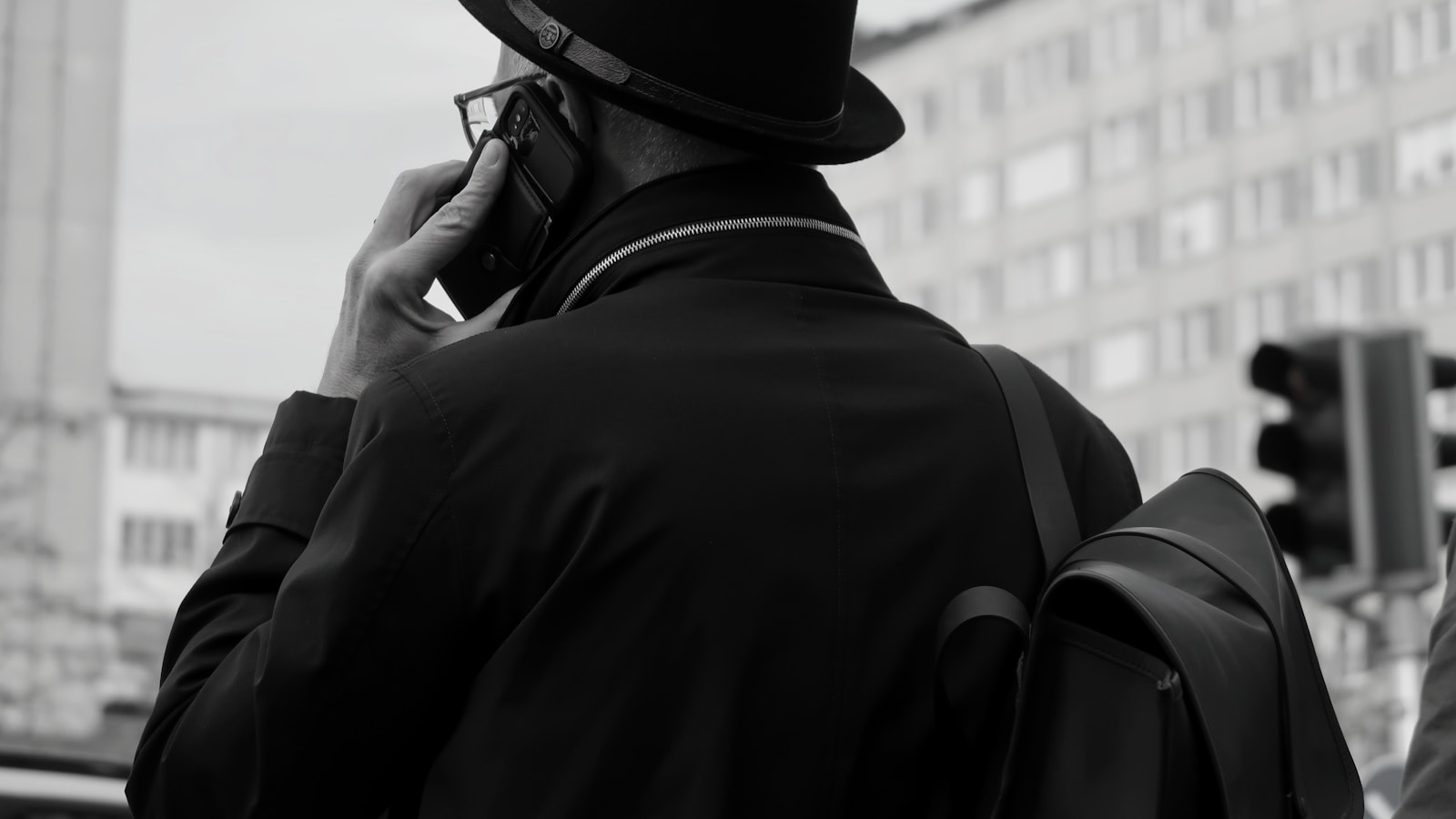 A man talks on the phone in the city.