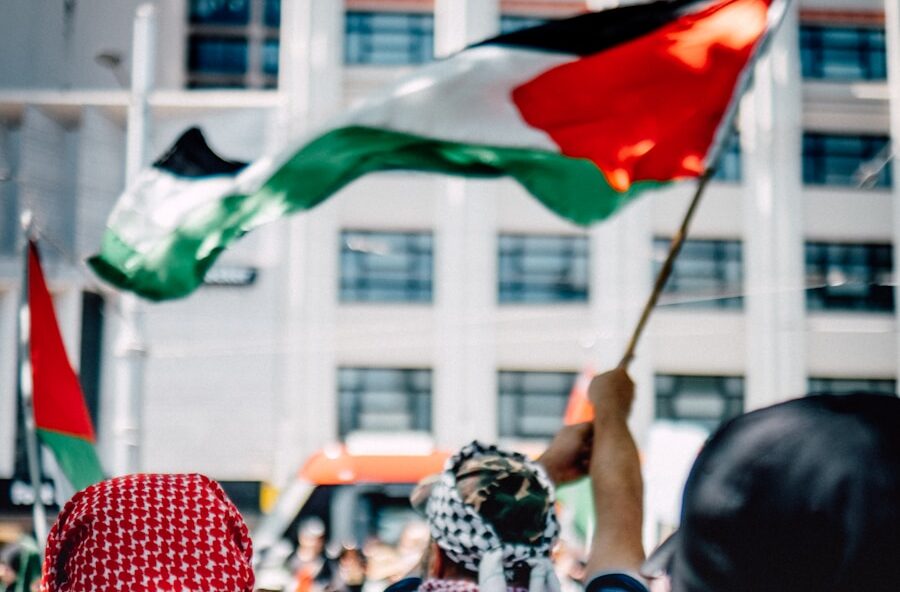 a group of people holding flags in front of a building