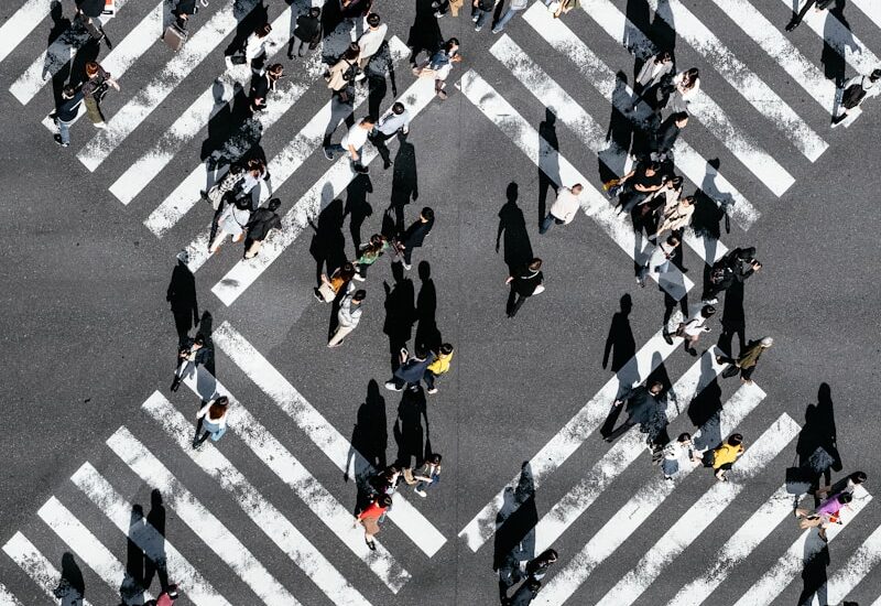 aerial view of people walking on cross pedestrian lane