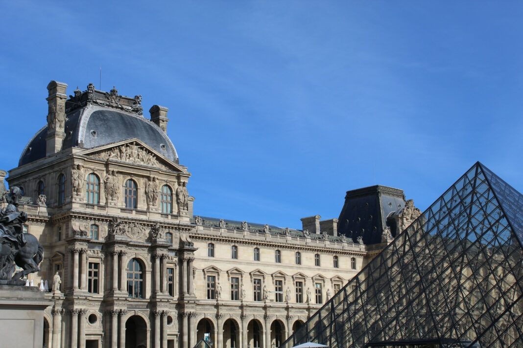 A large building with a pyramid in front of it