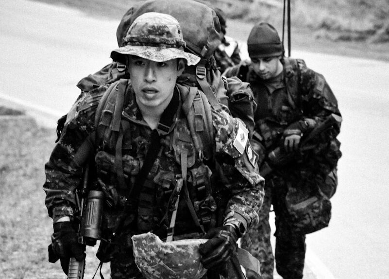 a group of soldiers walking down a road