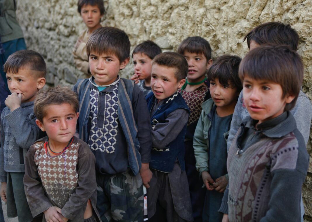 a group of young boys standing next to each other