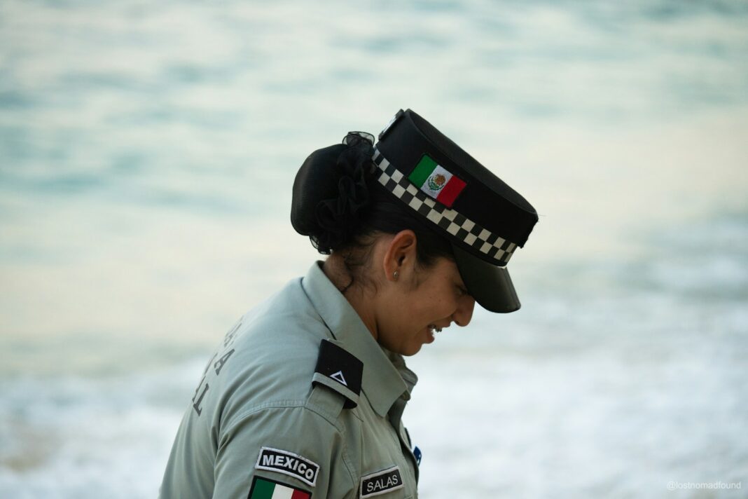 A mexican police officer stands by the water