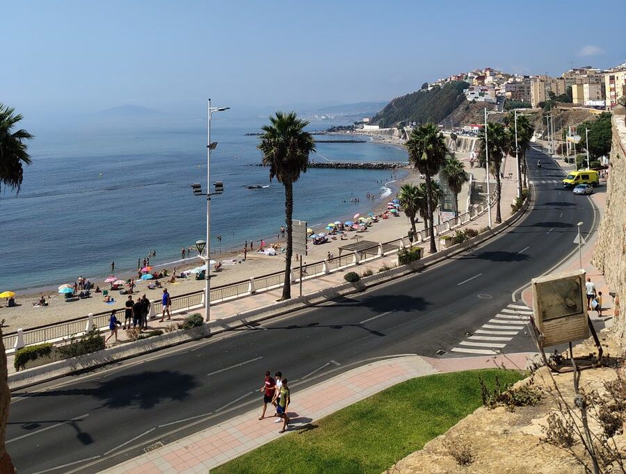 Stunning view of a coastal road along a busy beach in Algiers, Algeria.