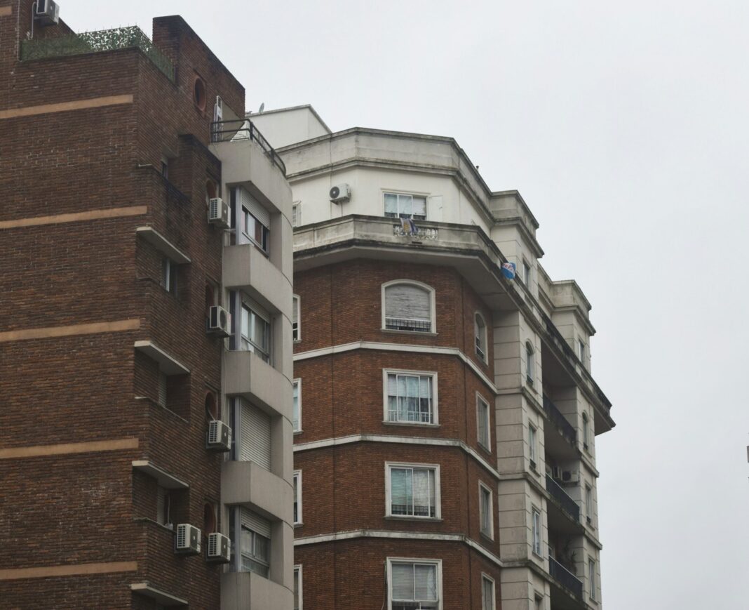a tall brick building with a clock on the top of it