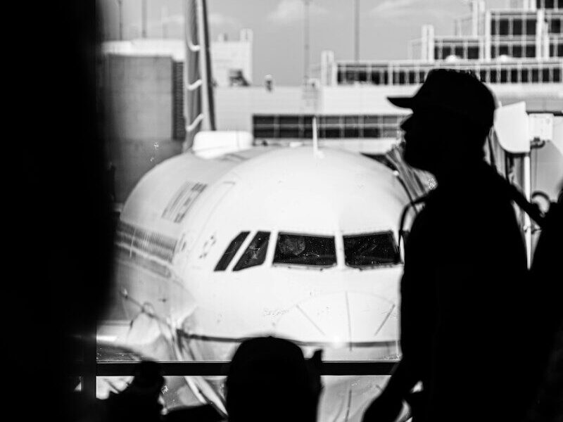 a man stands next to a plane