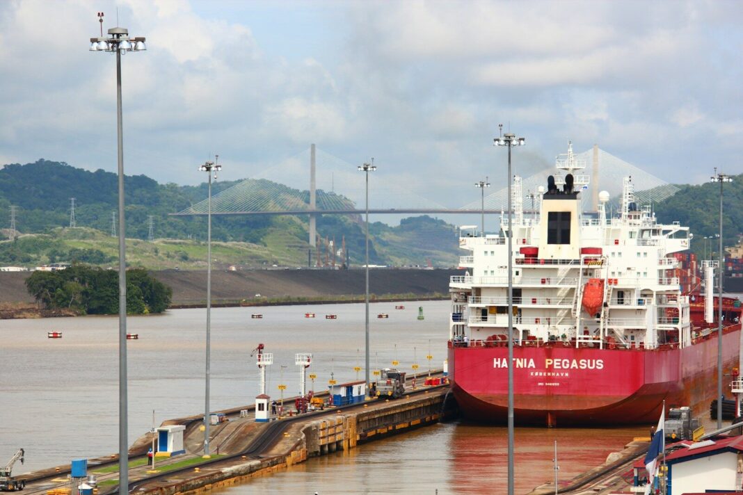 a large red and white boat docked at a dock